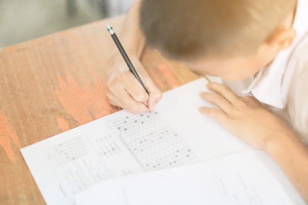 Asian,Student,Holding,Pencil,In,Hand,Doing,Multiple-choice,Quiz,Or